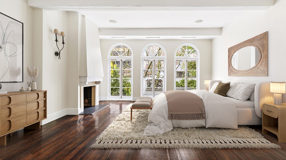 The bedroom features a fireplace and three windows.