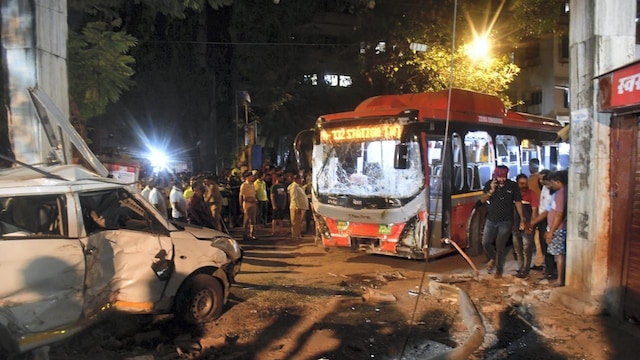 Security personnel and other people gather near the wreckage of vehicles after a Brihanmumbai Electric Supply and Transport (BEST) undertaking's bus rammed into pedestrians as well as vehicles on a road at Kurla, in Mumbai, Monday, Dec. 9, 2024. At least three people were killed and more than 20 others suffered injuries, according to officials. (PTI Photo)