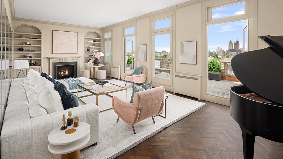 The living room boasts built-in cabinets and a wood-burning fireplace. 