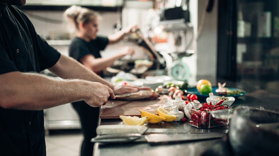 chefs prepare food in kitchen