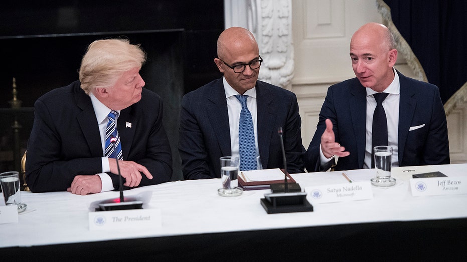 Jeff Bezos speaking with Trump