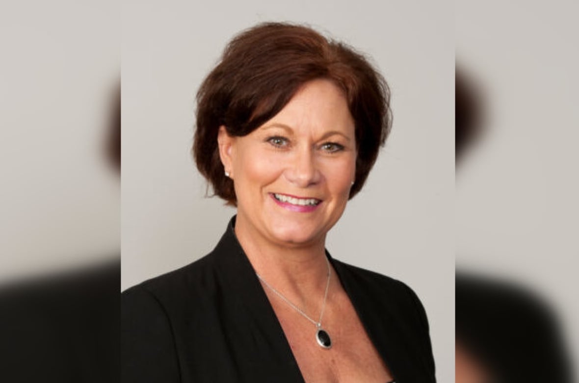 A woman with brown short hair poses for a portrait