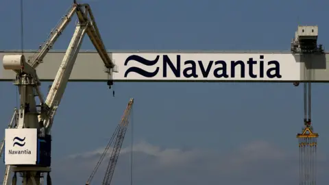 Getty Images Cranes of Spanish state-owned military shipyard Navantia. There are some clouds in the sky.