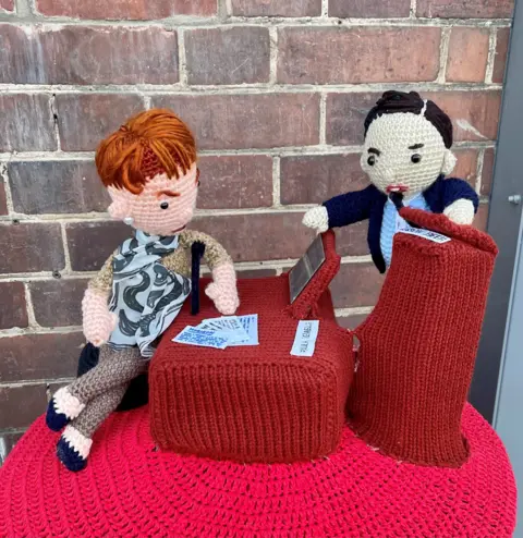 Richard Banks Abi Smith's knitted post box topper depicting Jason Beer questioning Paula Vennells at the Post Office inquiry