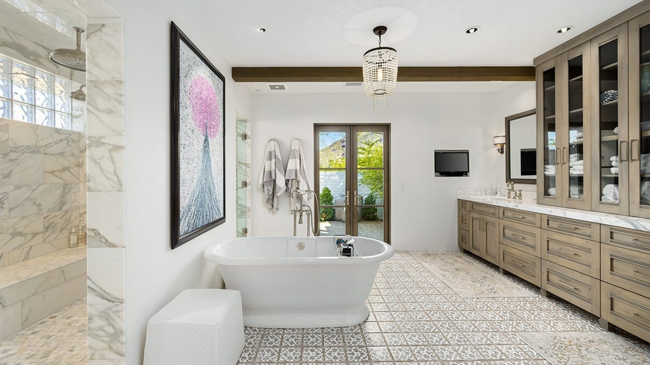 The ensuite bathroom boasts a stand-up shower, a soaking tub and access to the backyard.