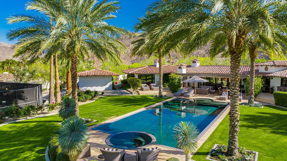 One of the main highlights of the home is the large backyard featuring a large grass field and swimming pool.