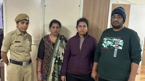 Bengaluru police Nikita Singhania (second from right) with her mother and brother after their arrest