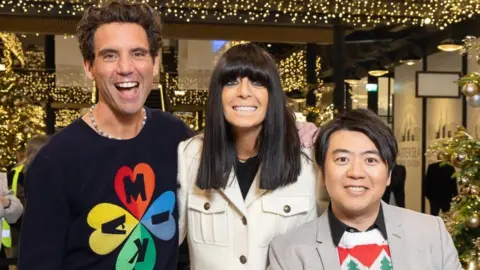 Channel 4 Claudia Winkleman, Mika and Lang Lang at Battersea Power Station, pictured under Christmas lights