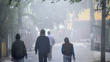 People walk amid fog on a cold winter morning, in Siliguri, Tuesday, Dec. 10, 2024. (PTI Photo)(