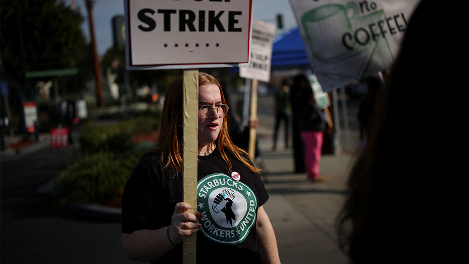 Barista holding a sign