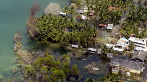 Getty Images This aerial view from an Indian Navy Helicopter taken 28 February 2005, shows an abandoned waterlogged coastal village on Kamorta Island, part of the Andaman and Nicobar Islands. India has given up hope of rebuilding six islands in the tsunami-hit Andaman and Nicobar archipelago where 5764 people are still listed as missing and some 40,500 people are placed in makeshift camps waiting for their homes to be rebuilt by the Integrated Relief Command (IRC), comprising the military and the civilian administration, set up by India to restore the Andamans. 