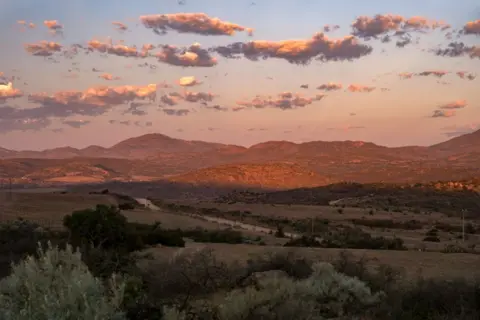 Getty Images Sunset over semi-desert landscape in the Namaqua National Park, Namaqualand, Northern Cape province, South Africa