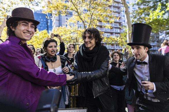 Finalists Miles Mitchell (left) and Zander Dueve (centre) shake hands at the Timothee Chalamet lookalike contest.