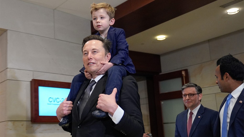 Elon Musk and his son X æ a-xii walking in the capital.