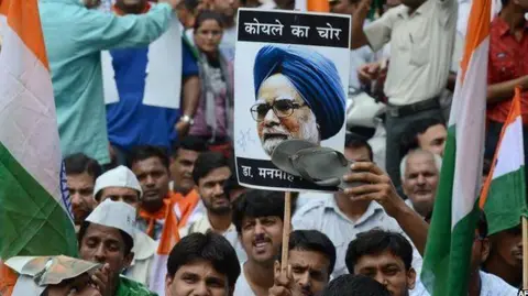 AFP An activist from India Against Corruption (IAC) stamps the picture of Manmohan Singh before marching towards the Prime Minister's residence in Delhi on August 26, 2012