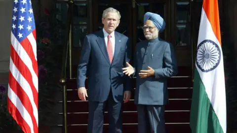 Getty Images In this picture taken 02 March 2006, US President George W Bush (L) and Indian Prime Minister Manmohan Singh stand next to each other prior to holding a bilateral meeting at Hyderabad House in Delhi. 