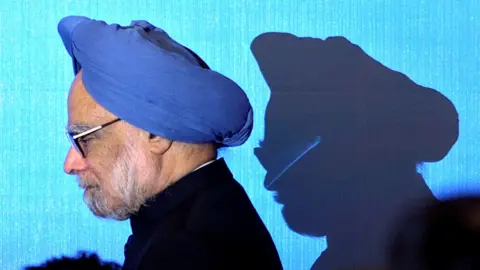 Reuters India's Prime Minister Manmohan Singh wearing a black suit and a blue turban walks on stage for a photo opportunity as part of the 5th East Asia Summit in Hanoi, Vietnam, October 30, 2010. 