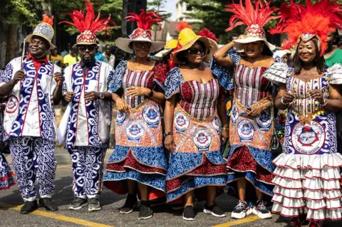 Olympia De Maismont / AFP A troupe from the University of Calabar pose in outfits made from material printed with the university's logo