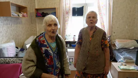 Valentyna and Mariia, two elderly displaced women, are pictured in temporary accommodation