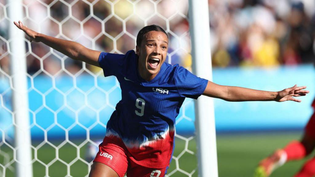 Mallory Swanson celebrates scoring for the United States