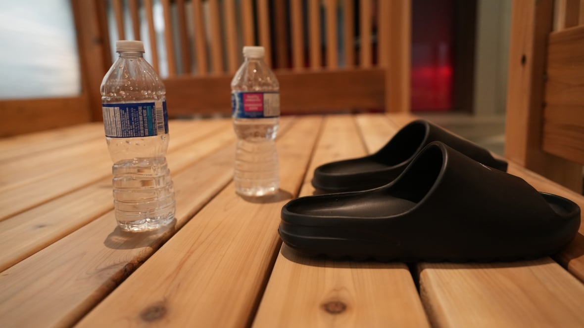 A pair of sandals and two water bottles are left outside a sauna at Calgary's Clear Nordic Spa.