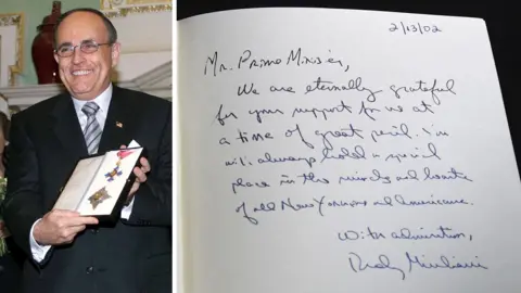 Getty Images A composite image shows one of the Downing Street books signed by Rudy Giuliani on the right, and on the left, an image of him on 13 February 2002 smiling while receiving the KBE.