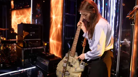 TONY DOLCE/BBC Sophie Ellis-Bextor holding a bass guitar which has been made from a Millennium Falcon Star Wars toy.