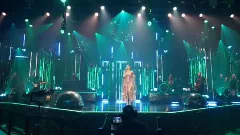 TONY DOLCE/BBC Sophie Ellis-Bextor during rehearsals for her New Year's Eve Disco concent on BBC1. She is singing beneath what is claimed to be the country's biggest disco ball