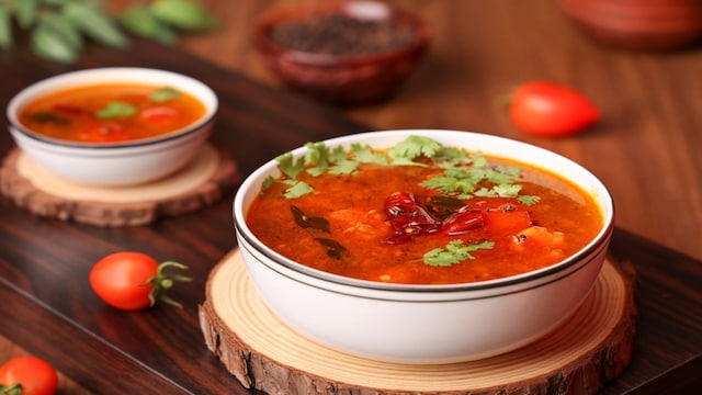 Rasam | One of the popular South Indian recipes, rasam, is often referred to as the staple food. It is a thin, spicy soup usually served as a side dish with rice. The prime ingredients used in this are jaggery, tamarind, tomato, and lentil. (Image: Shutterstock)