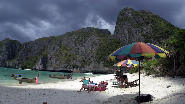 Foreign tourists catch the sun's rays on remote Maya Beach in southern Thailand February 27, now made famous as the shooting location of the new [Leonardo DiCaprio] film, "The Beach" which is being released in Thailand's cinemas March 7. Exotic country Thailand is set to lure a record 8.8 million tourists this year and rake in over US$8 billion in earnings that will underpin national economic revival, [says Pradech Phayakvichien], the governer of Thailand's tourism authority in an interview with Reuters.