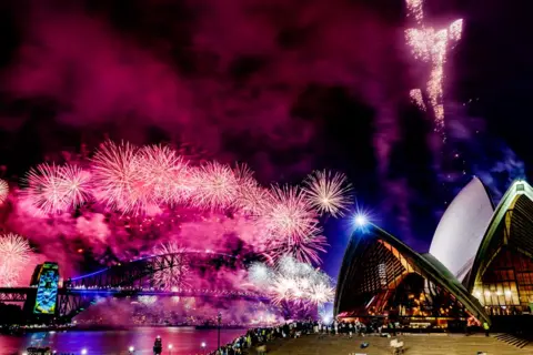 SAEED KHAN/AFP Fireworks light up the midnight sky over Sydney Harbour Bridge and Sydney Opera House during 2025 New Year's Day celebrations in Sydney on January 1, 2025.