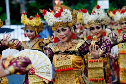 SONNY TUMBELAKA/AFP Balinese traditional dancers perform during the dance of releasing the sun 2024, welcoming the sun 2025 a New Year's Eve celebration in Denpasar on Indonesia's resort island of Bali on December 31, 2024.