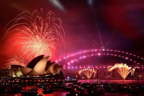 Bianca De Marchi/AAP Image via REUTERS The 9pm fireworks explode during New Year’s Eve celebrations in Sydney, Australia, December 31, 2024.  Pink fireworks can bee seen exploding above Opera House and the Sydney Harbour Bridge.