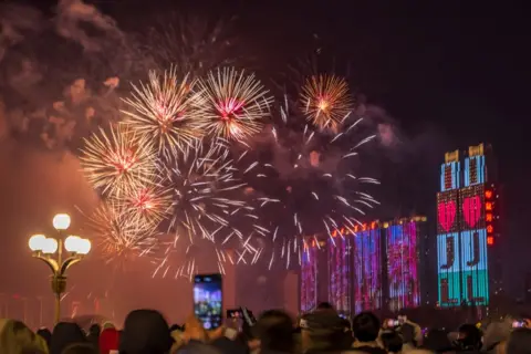 VCG via Getty Images Fireworks light up the sky over the Songhua River during a firework show to welcome New Year 2025 on New Year's Eve on December 31, 2024 in Jilin City, Jilin Province of China. 