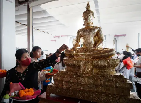 RUNGROJ YONGRIT/EPA Thai Buddhists gather to mark the New Year at the City Pillar Shrine in Bangkok, Thailand, 31 December 2024. 