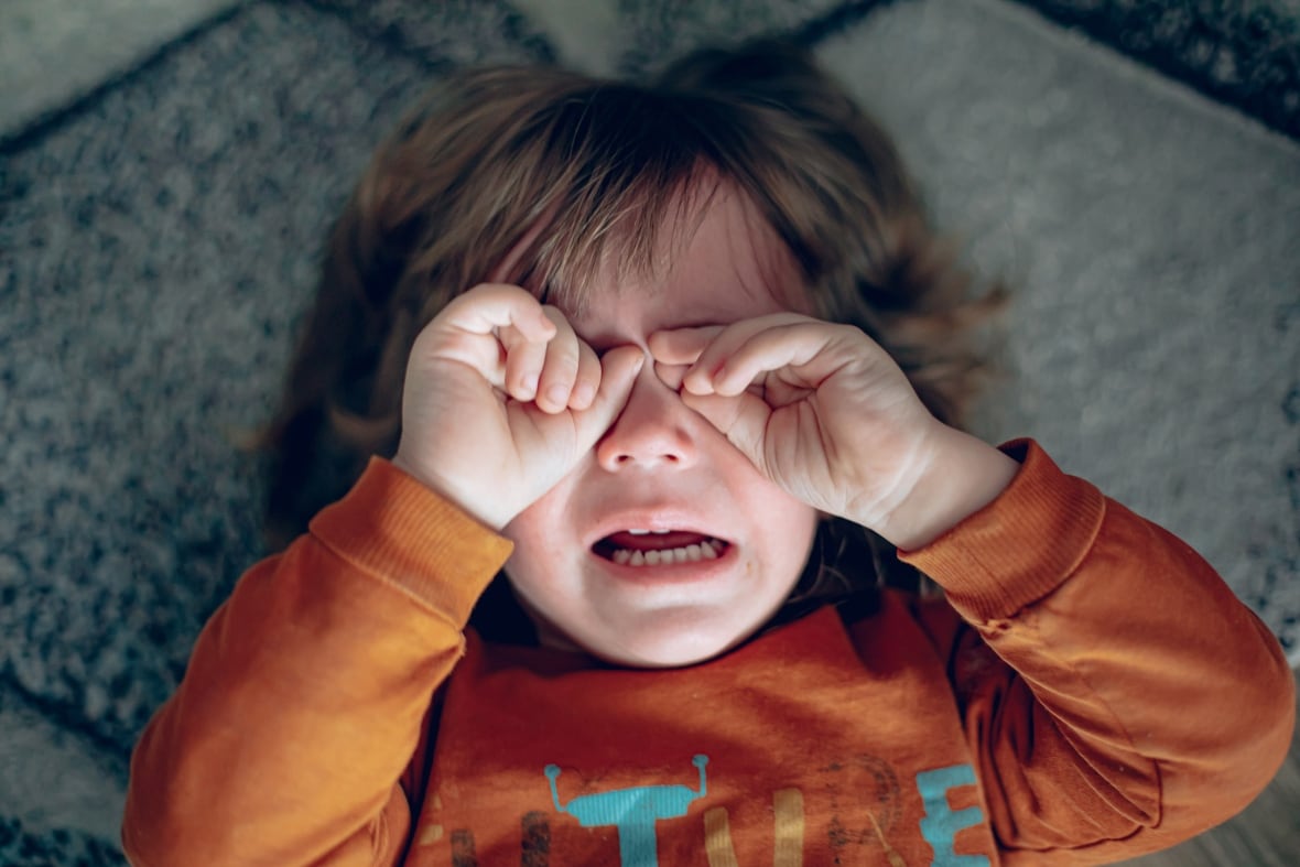 Close up portrait of crying little toddler boy