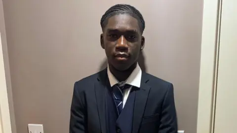 Detained in Dubai Marcus Fakana in school uniform