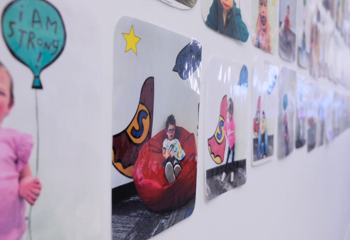 Pictures of children hang on the wall of a physical therapy clinic.