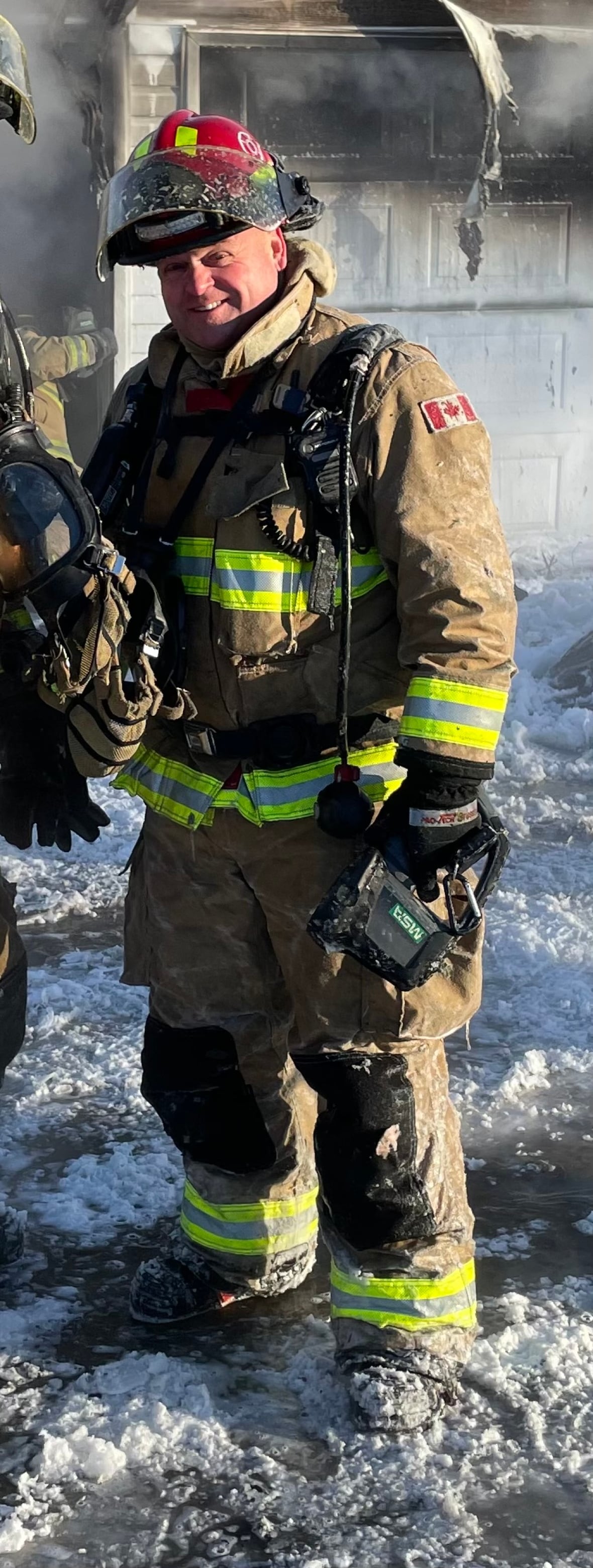 Firefighter stands in snow.