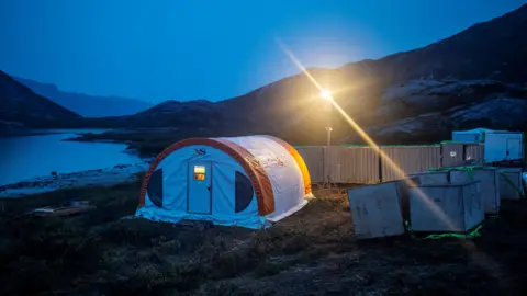 Reuters A tent with a bright light above it during twilight at the camp of the exploration site of the company Greenland Anorthosite Mining close to the Qeqertarsuatsiaat fjord, Greenland