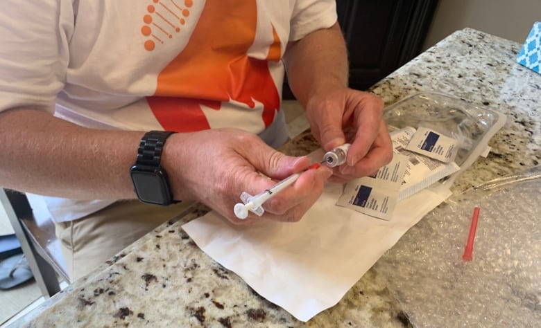 A man prepares a needle.