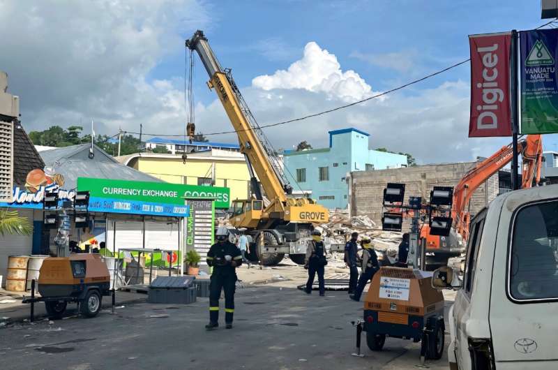 Rescue workers are seen on December 19, 2024 at a collapsed building from Vanuatu's first earthquake, in a photo taken and released by the Australian Department of Foreign Affairs and Trade