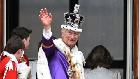 Getty Images King Charles wearing the Imperial State Crown. He is wearing purple robes. 