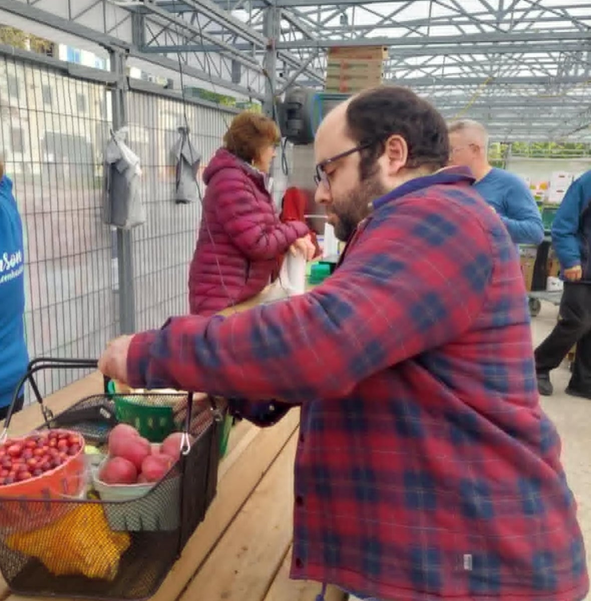 A man buys some produce at a market.