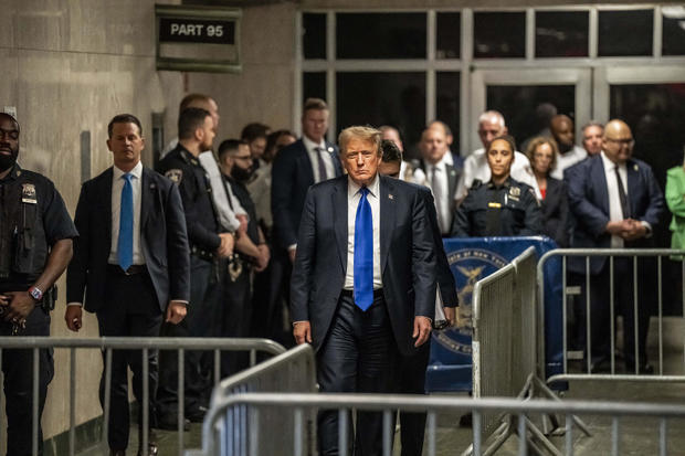 Former President Donald Trump walks out of court and toward the media following the verdict in his 