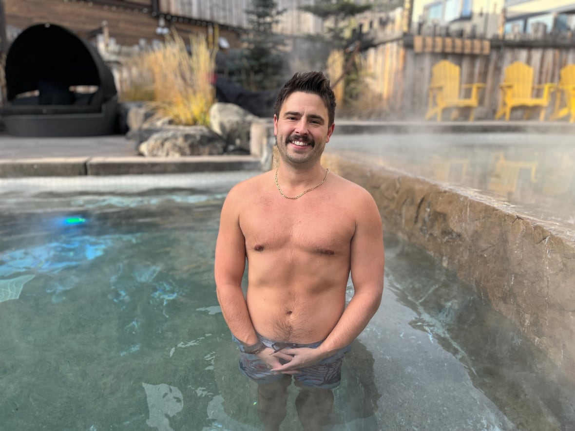 A man is pictured inside the hot tub at the Kananaskis Nordic Spa in Alberta.