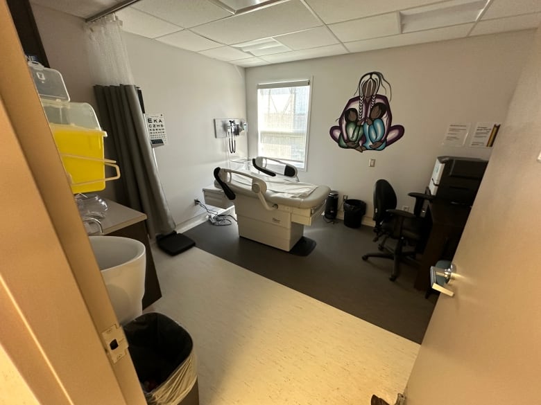 A clinic room with a bed for a patient.