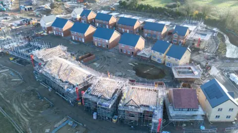 Getty Images A aerial view of new houses being constructed on what was previously agricultural land in England