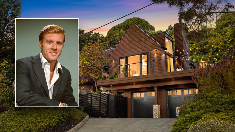 Exterior shot of Robert Redford home of brown shingled home with black garage doors inset a Robert Redford in just a suit