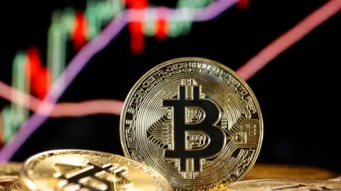 Getty A picture of a bitcoin with a sharply rising graph behind it